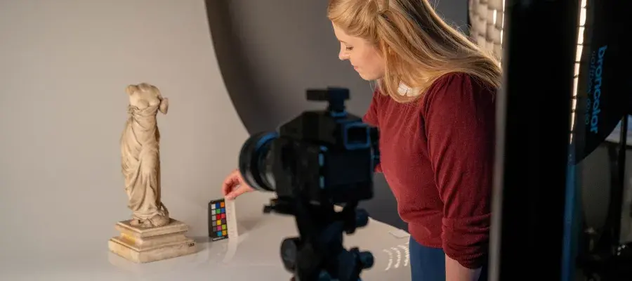 This image shows a member of staff photographing collections.